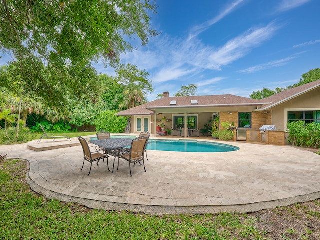 view of pool featuring french doors, a patio area, and a grill