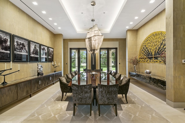 dining space featuring a tray ceiling and a notable chandelier