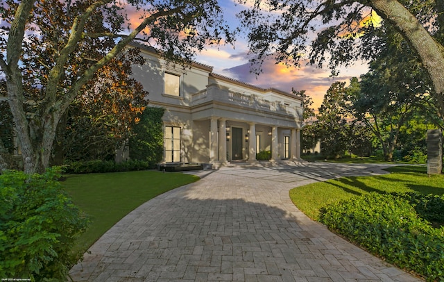 neoclassical home with a yard