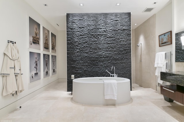 bathroom with vanity and a tub to relax in