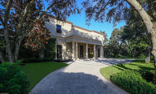 greek revival inspired property with a front yard