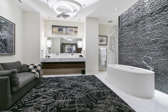 bathroom with vanity and a washtub