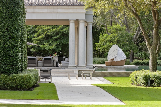 view of community with a gazebo, outdoor lounge area, a patio, and a lawn