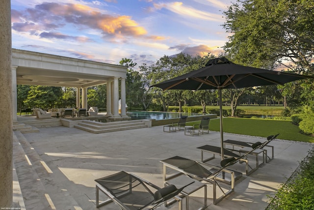 view of home's community with a swimming pool, a patio, and a water view