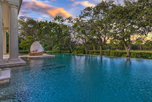 view of pool at dusk