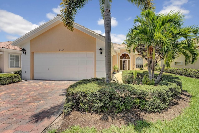 mediterranean / spanish-style home with a garage