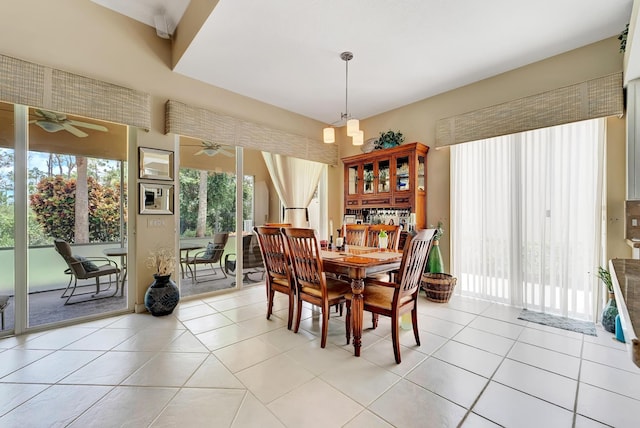 dining space featuring light tile patterned flooring and ceiling fan