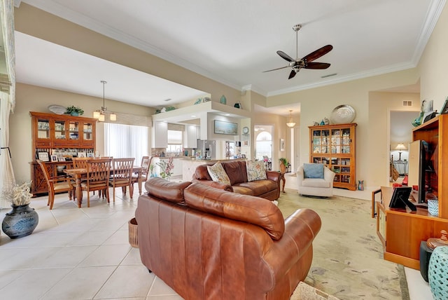 tiled living room with ceiling fan, a healthy amount of sunlight, and crown molding