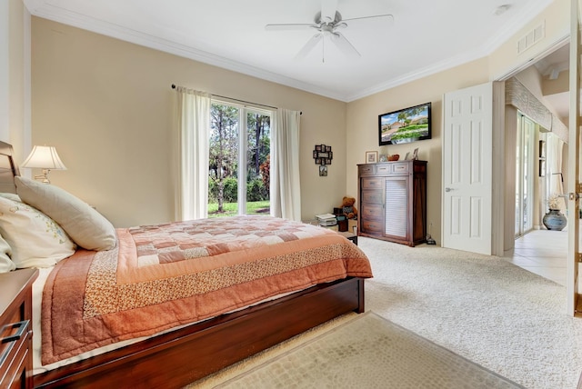 carpeted bedroom featuring ceiling fan and ornamental molding