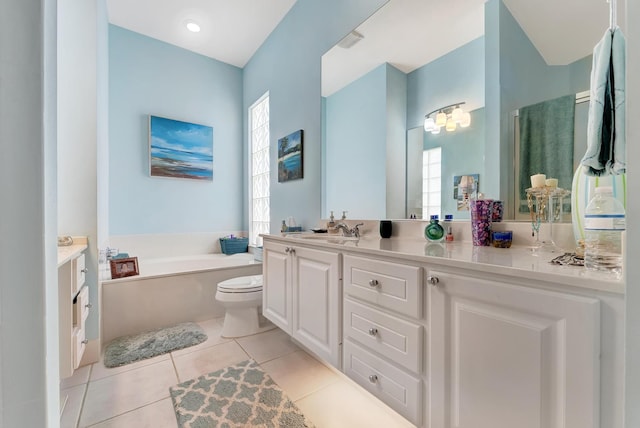 bathroom with a washtub, toilet, vanity, and tile patterned flooring