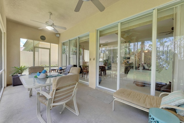 sunroom featuring ceiling fan