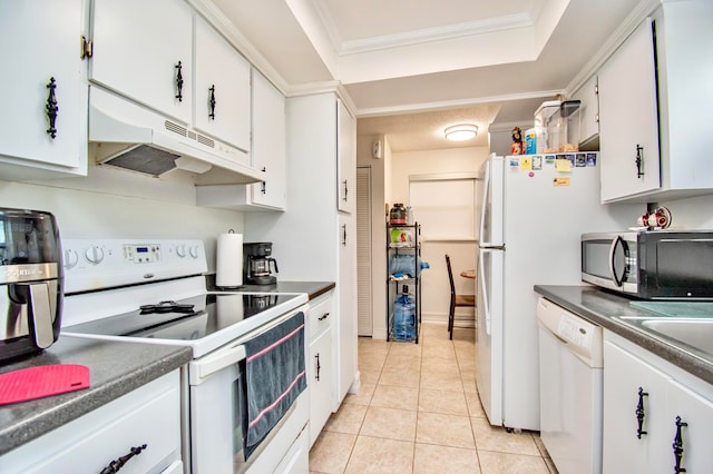 kitchen with a tray ceiling, white cabinets, white appliances, ornamental molding, and light tile patterned floors