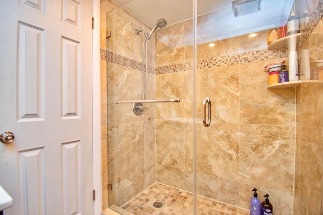 bathroom with a shower with door