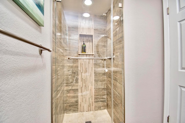 bathroom with a tile shower