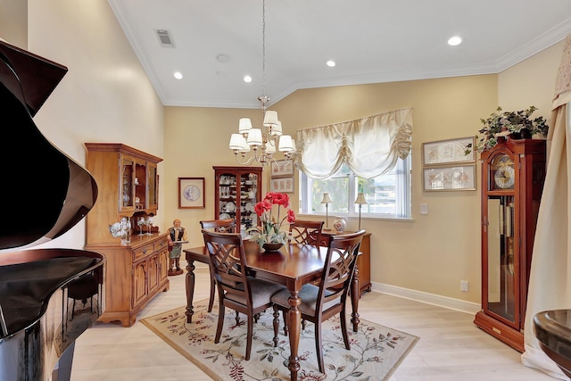 dining space with a chandelier, light hardwood / wood-style floors, and ornamental molding