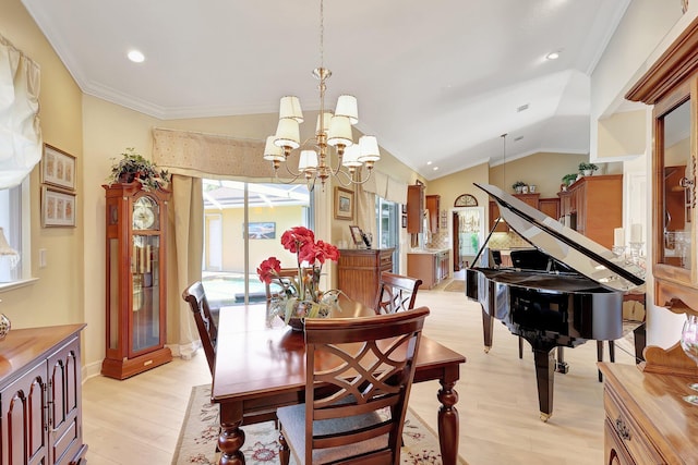 dining space with crown molding, light hardwood / wood-style floors, lofted ceiling, and an inviting chandelier