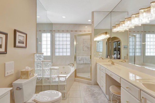 bathroom with tile patterned flooring, vanity, and shower with separate bathtub