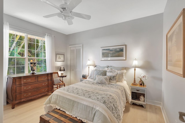 bedroom with a closet, ceiling fan, and light hardwood / wood-style floors