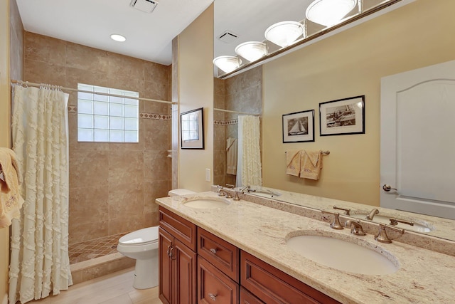 bathroom featuring a shower with curtain, vanity, toilet, and tile patterned floors