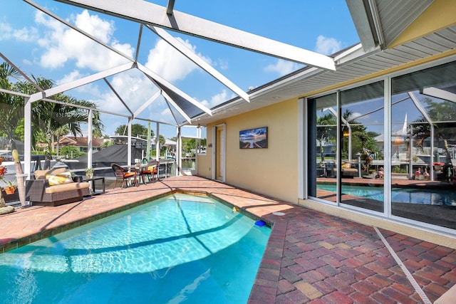 view of swimming pool with glass enclosure and a patio area