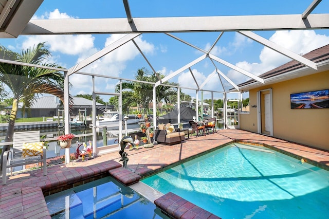 view of swimming pool featuring glass enclosure, a water view, and a patio