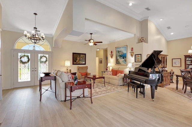 living room with french doors, light hardwood / wood-style floors, and ornamental molding