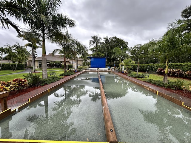 view of swimming pool with a yard