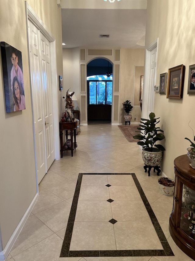 foyer featuring light tile patterned floors, visible vents, and baseboards