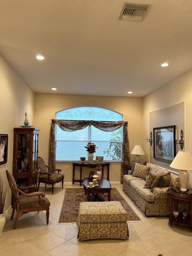 living area with light tile patterned floors, baseboards, visible vents, and recessed lighting