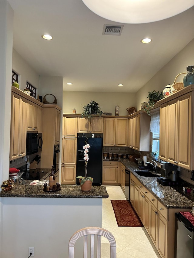 kitchen featuring visible vents, a peninsula, black appliances, a sink, and recessed lighting