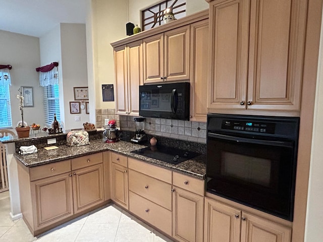 kitchen featuring dark stone counters, kitchen peninsula, tasteful backsplash, light tile flooring, and black appliances