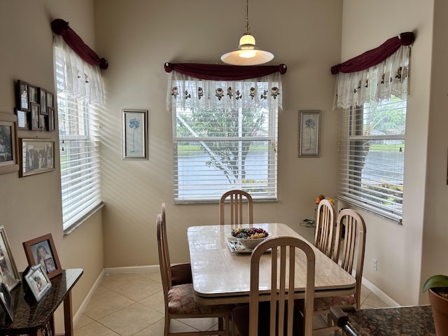 dining space with light tile patterned flooring and baseboards