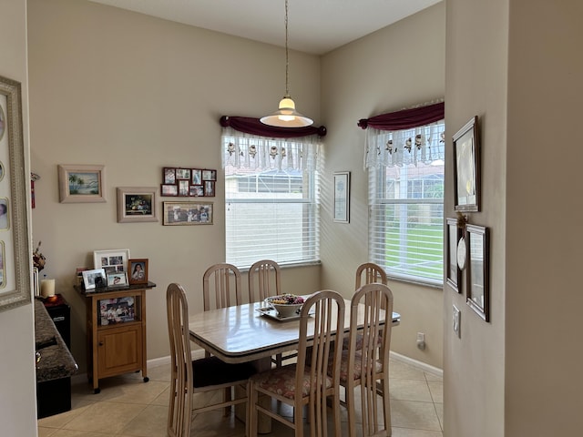 dining room with light tile patterned floors and baseboards
