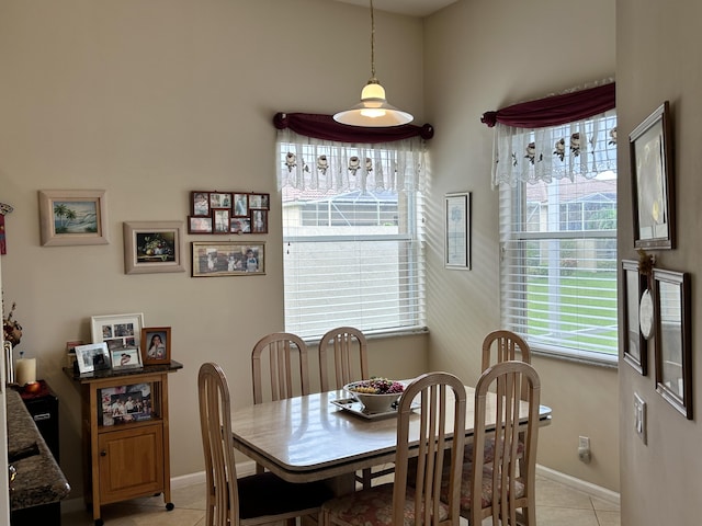 dining area featuring baseboards and light tile patterned floors