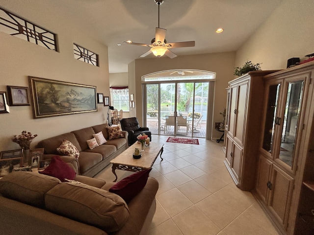 living area featuring light tile patterned floors, a ceiling fan, and recessed lighting
