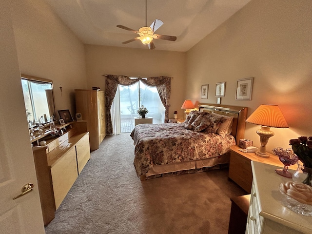 bedroom with carpet floors, access to outside, a towering ceiling, and a ceiling fan