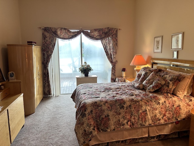 carpeted bedroom with access to exterior