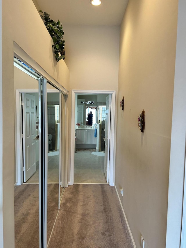 hall featuring baseboards, carpet flooring, and recessed lighting
