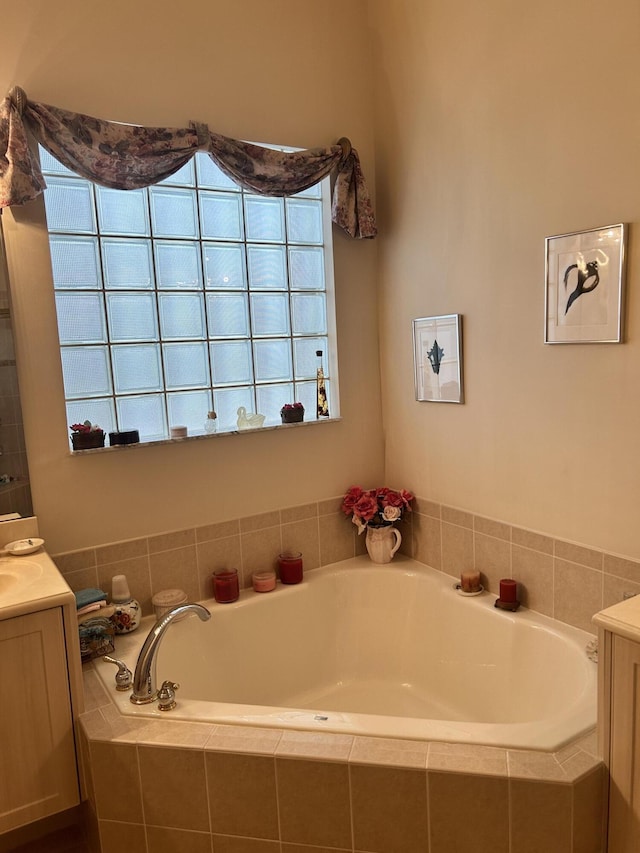 full bathroom featuring a garden tub and vanity