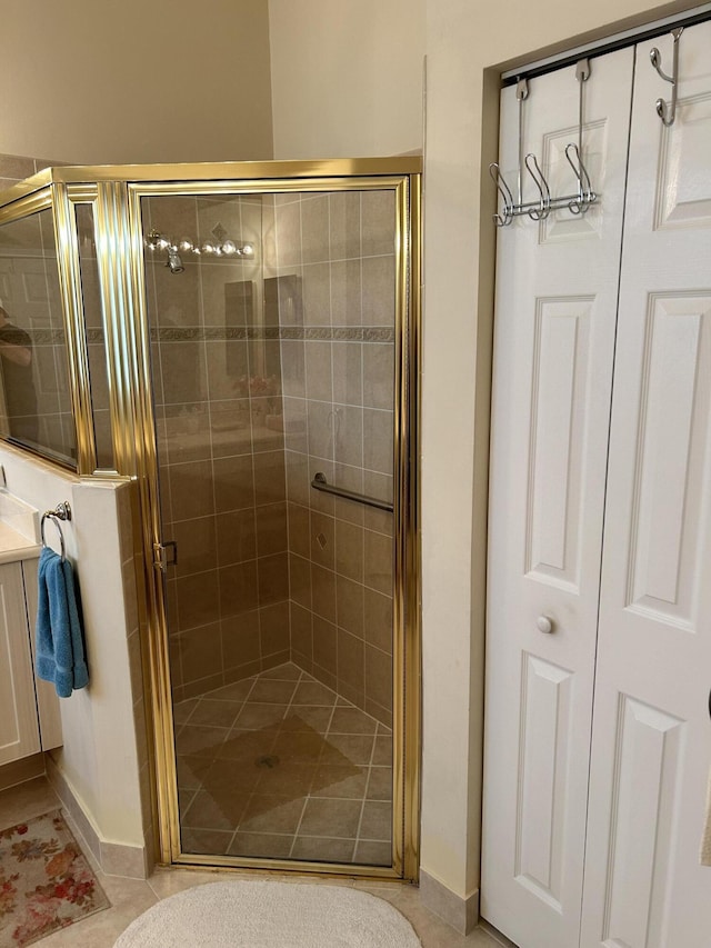 full bathroom featuring a stall shower, tile patterned flooring, and baseboards