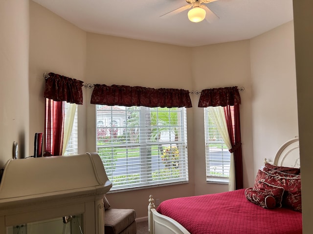 bedroom with multiple windows and a ceiling fan
