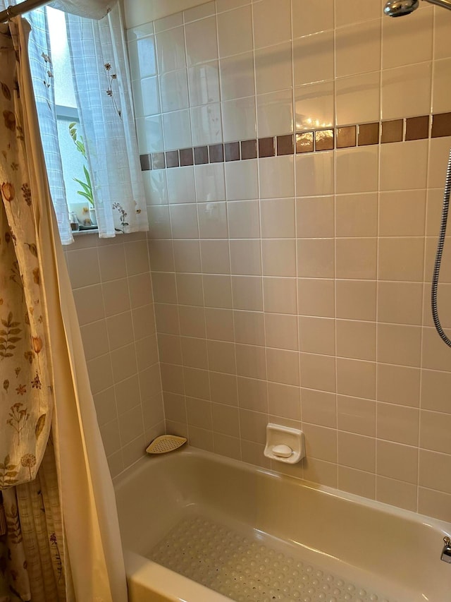 bathroom with shower / bathtub combination with curtain