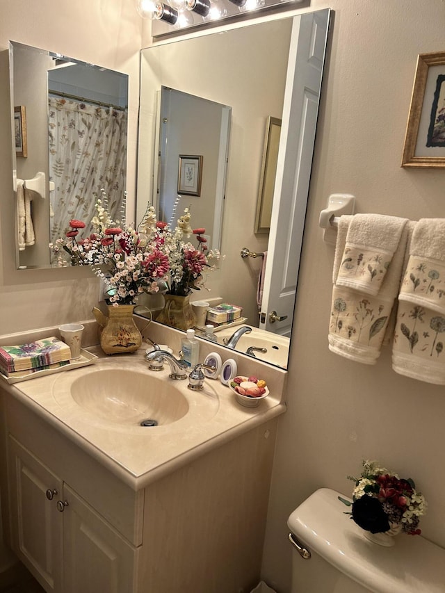 full bathroom featuring vanity and toilet