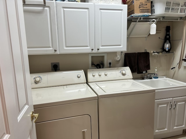 laundry area featuring a sink, cabinet space, and washer and dryer