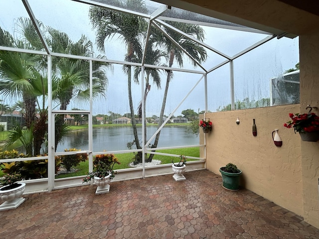 unfurnished sunroom with a water view