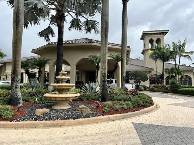 view of front of property featuring a tile roof and stucco siding