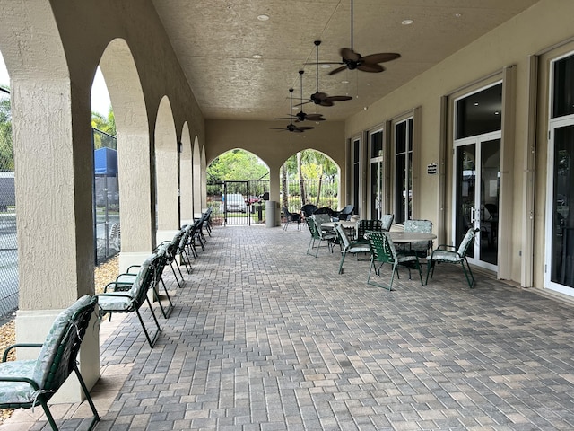 view of patio / terrace featuring fence and a ceiling fan