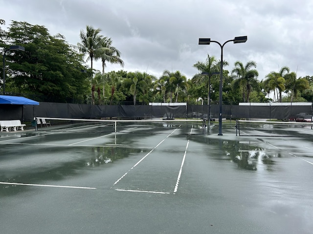view of sport court featuring fence