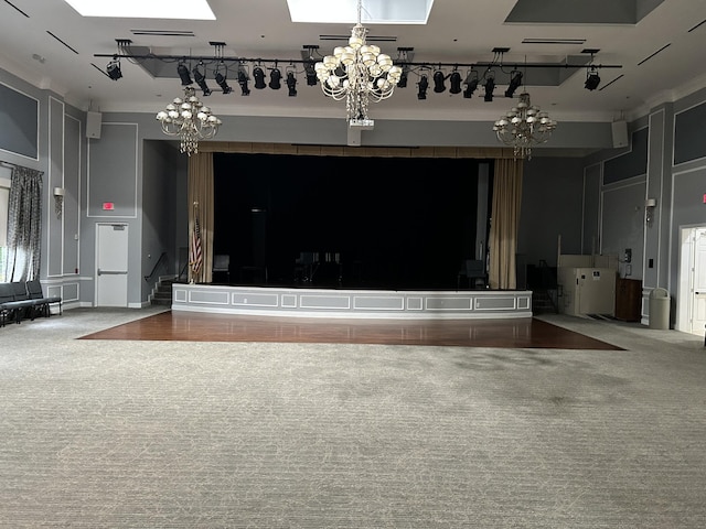 interior space featuring a skylight, a notable chandelier, and stairway
