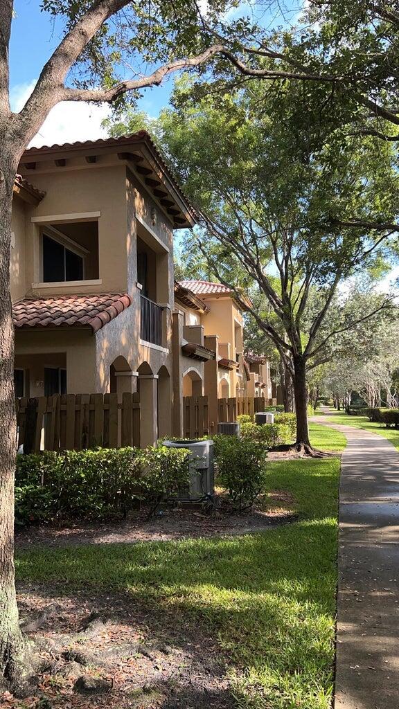 view of property exterior with a balcony and a lawn